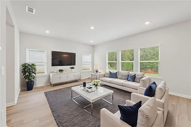 a view of an empty room with wooden floor