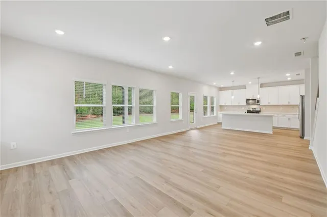 a view of large kitchen with wooden floor and outdoor space