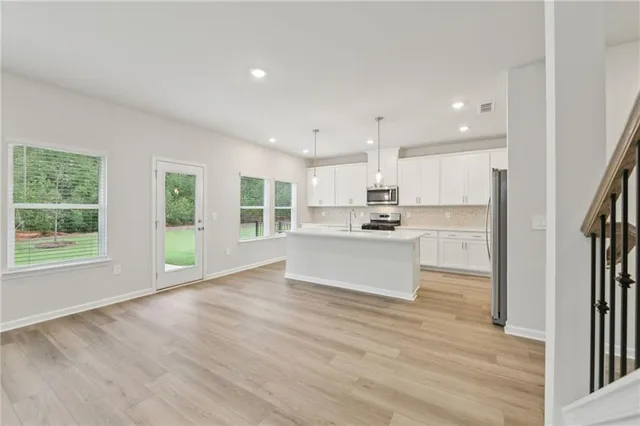a view of a dining room with furniture and a floor to ceiling window