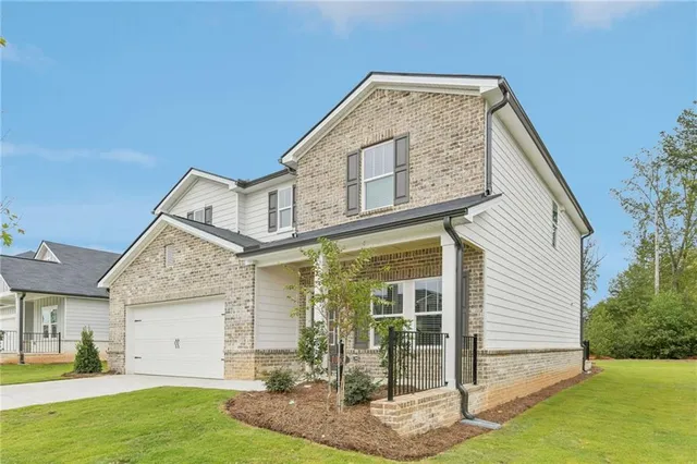 a front view of a house with a yard
