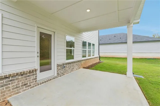 a view of a house with backyard and wooden fence
