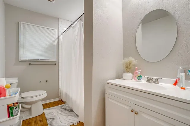 a bathroom with a sink toilet and a mirror