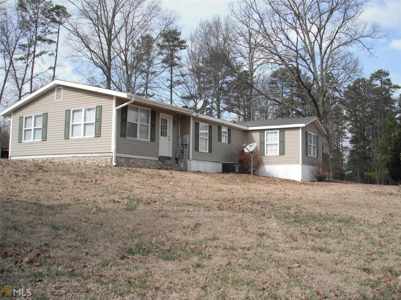 41 Wooten Road Cedartown, GA 30125 - Photo 1 of 1 a front view of a house with a garden and trees