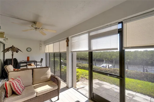 a living room with furniture and a floor to ceiling window