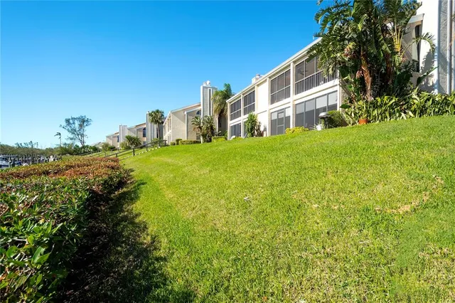 a view of a large building with big yard and large trees