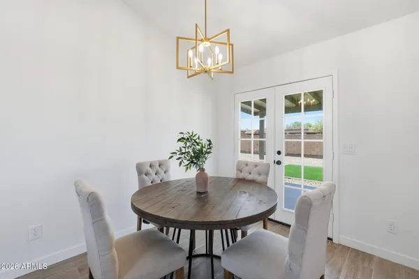 a view of a dining room with furniture and a potted plant