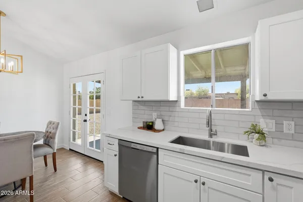 a kitchen with a sink a window and cabinets