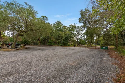 a view of dirt field with trees