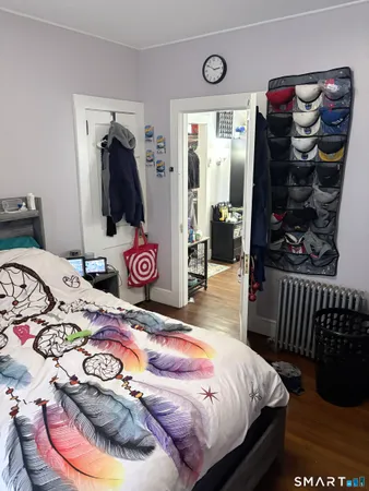 a bedroom with a bed and a dresser