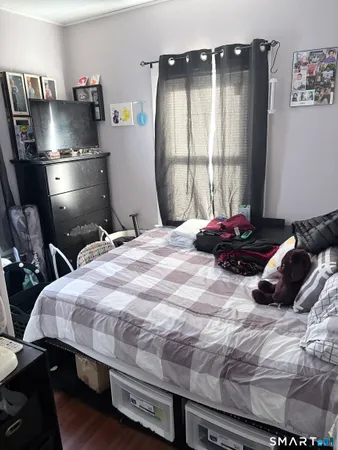 a bedroom with a bed and a window