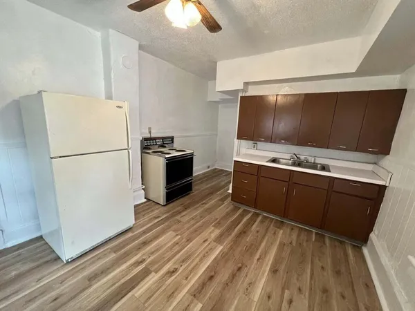 a kitchen with stainless steel appliances a refrigerator stove and microwave