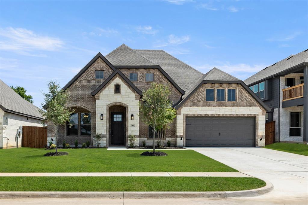 713 Seahawk Street Joshua, TX 76058 - Photo 28 of 31 a front view of a house with a yard and garage