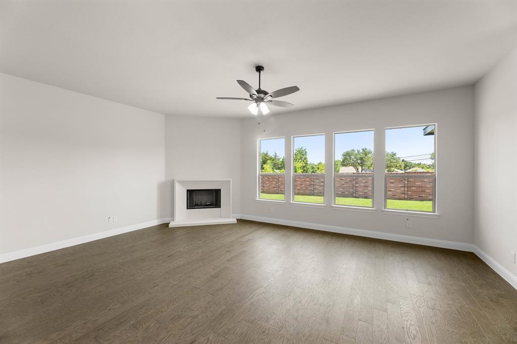 713 Seahawk Street Joshua, TX 76058 - Photo 7 of 31 an empty room with wooden floor and windows