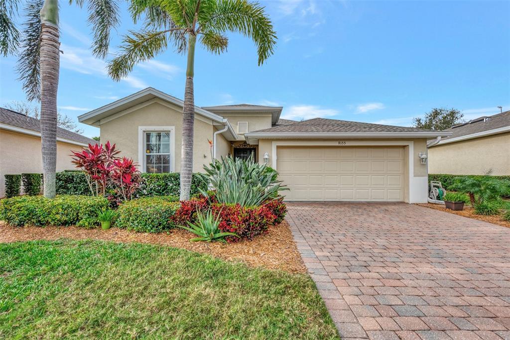 9155 Coachman Drive Venice, FL 34293 - Photo 1 of 1 a front view of a house with a yard and a porch