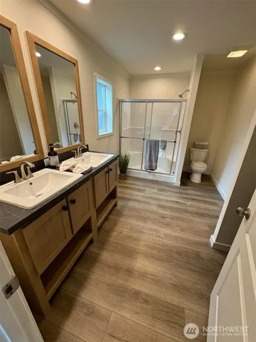 a spacious bathroom with a double vanity sink and a mirror
