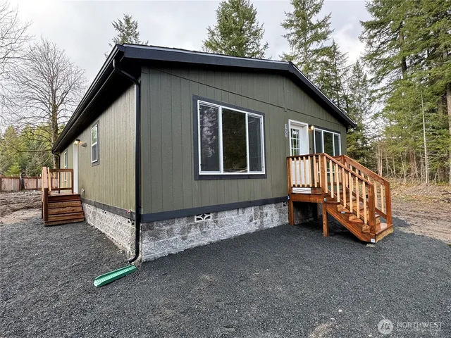 a view of a house with a yard and deck