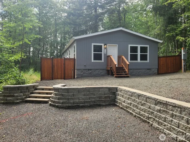 a view of backyard with deck and outdoor seating
