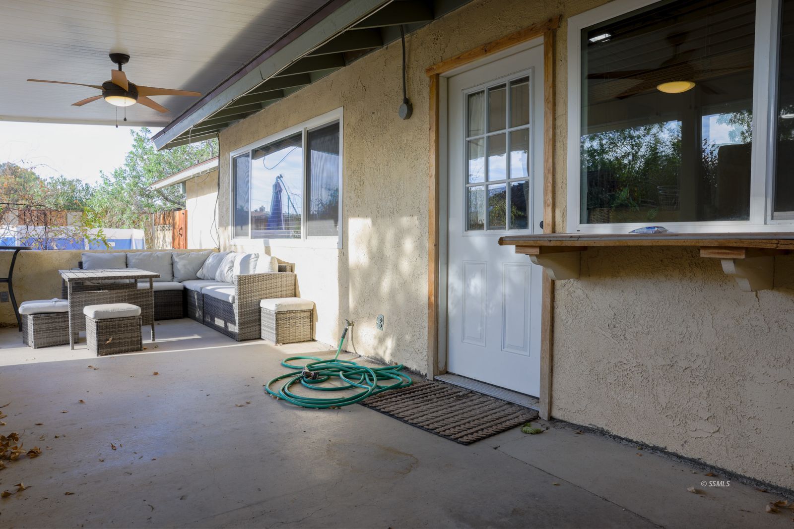 1051 Peg Street Ridgecrest, CA 93555 - Photo 26 of 34 a view of a porch with furniture and floor to ceiling window
