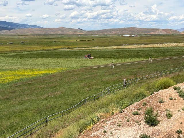 1325 South Round Road East Laketown, UT 84038 - Photo 40 of 40 Expansive agricultural landscape featuring green fields, distant mountains, and visible irrigation systems