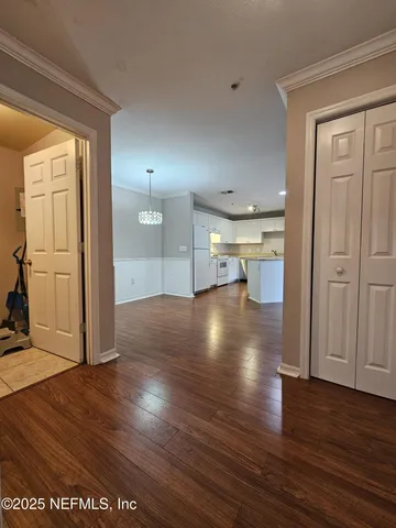 a view of a room with wooden floor