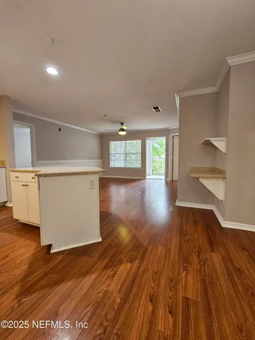a view of a room with wooden floors and stairs