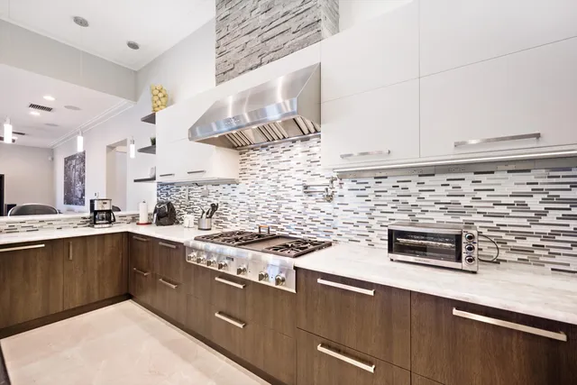 a kitchen with stainless steel appliances a stove and a sink