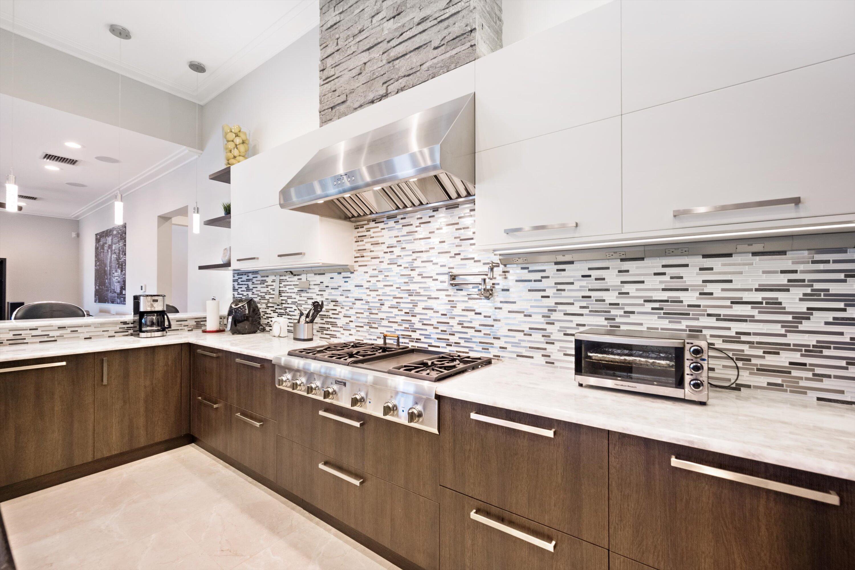 15880 Barnstormer Court Wellington, FL 33414 - Photo 12 of 48 a kitchen with stainless steel appliances a stove and a sink