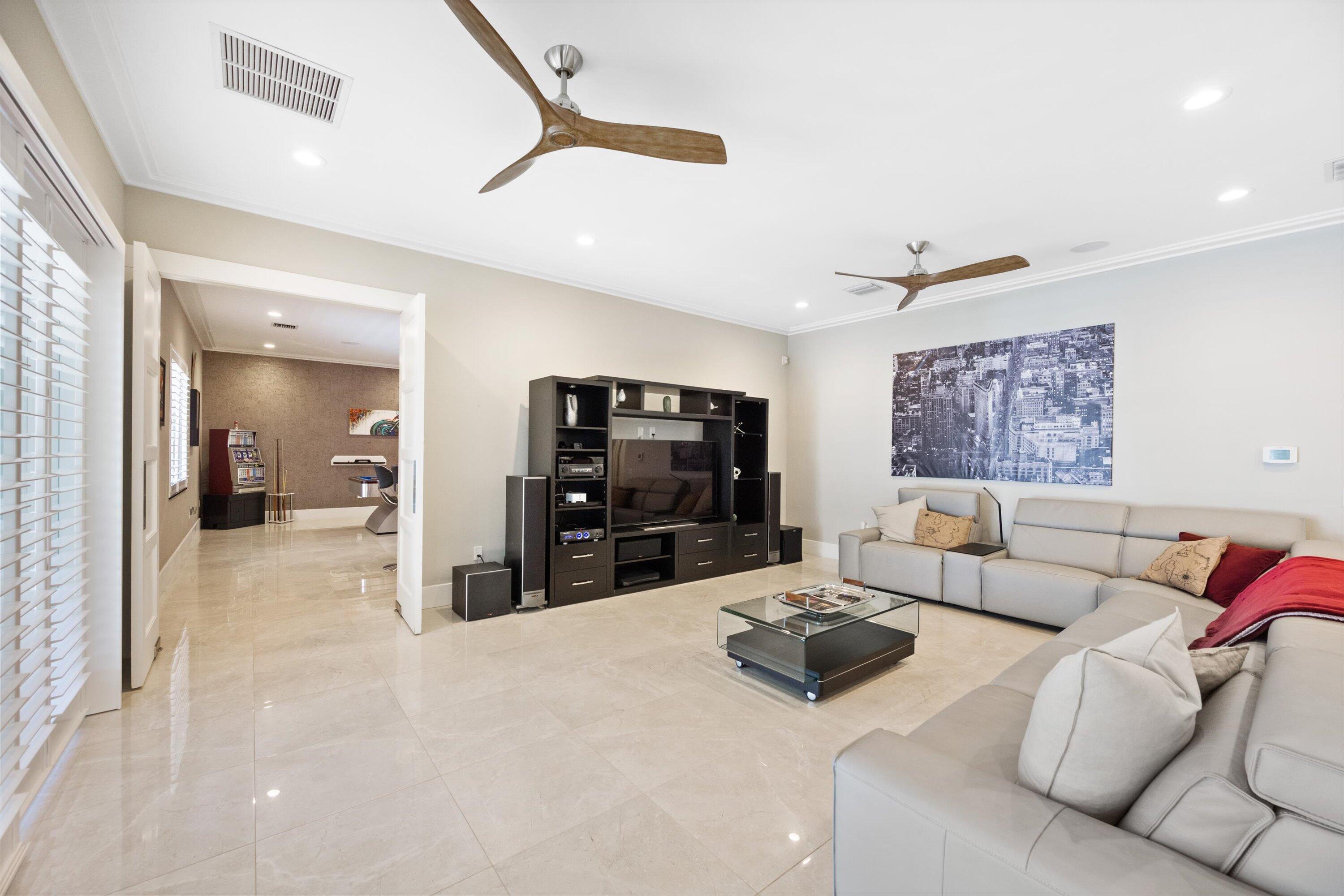 15880 Barnstormer Court Wellington, FL 33414 - Photo 16 of 48 a living room with furniture and a flat screen tv