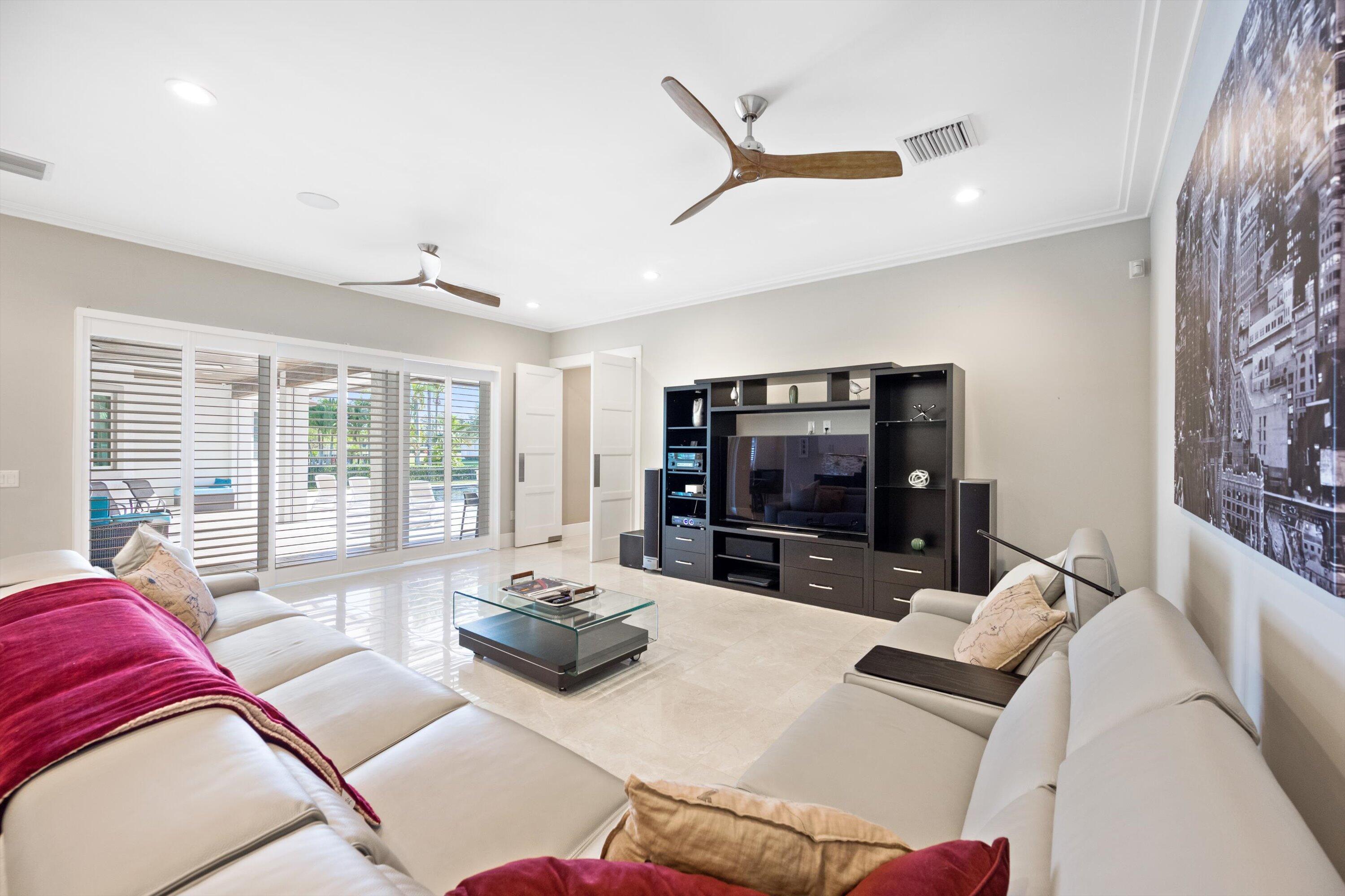 15880 Barnstormer Court Wellington, FL 33414 - Photo 18 of 48 a living room with furniture and a flat screen tv