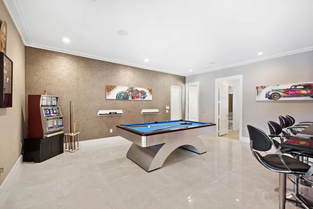 a room with furniture pool table and gym equipment