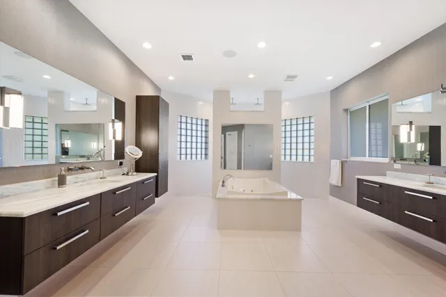 a large white kitchen with a large window