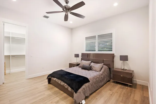 a bedroom with a bed and wooden floor