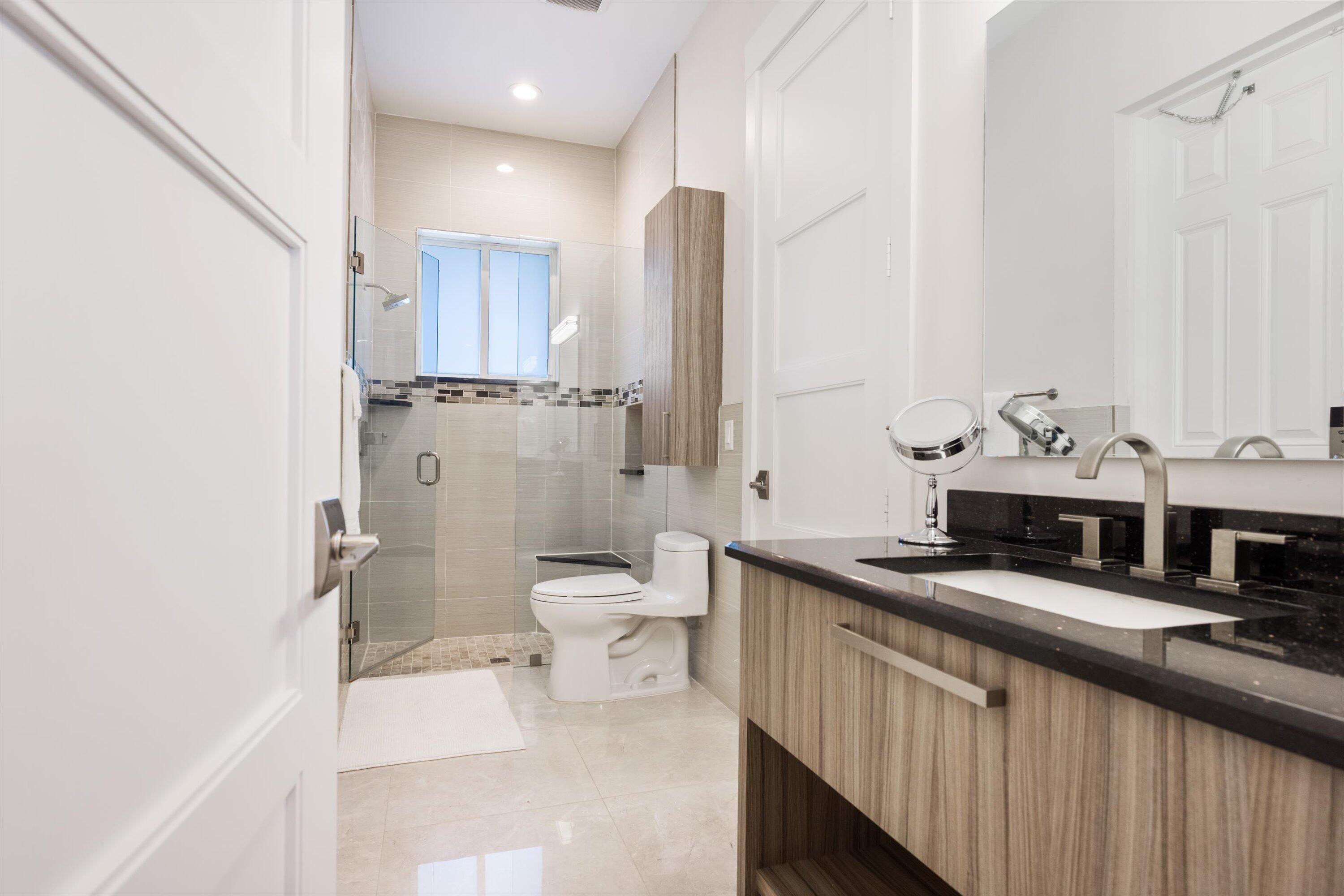 15880 Barnstormer Court Wellington, FL 33414 - Photo 35 of 48 a bathroom with a sink a toilet and shower