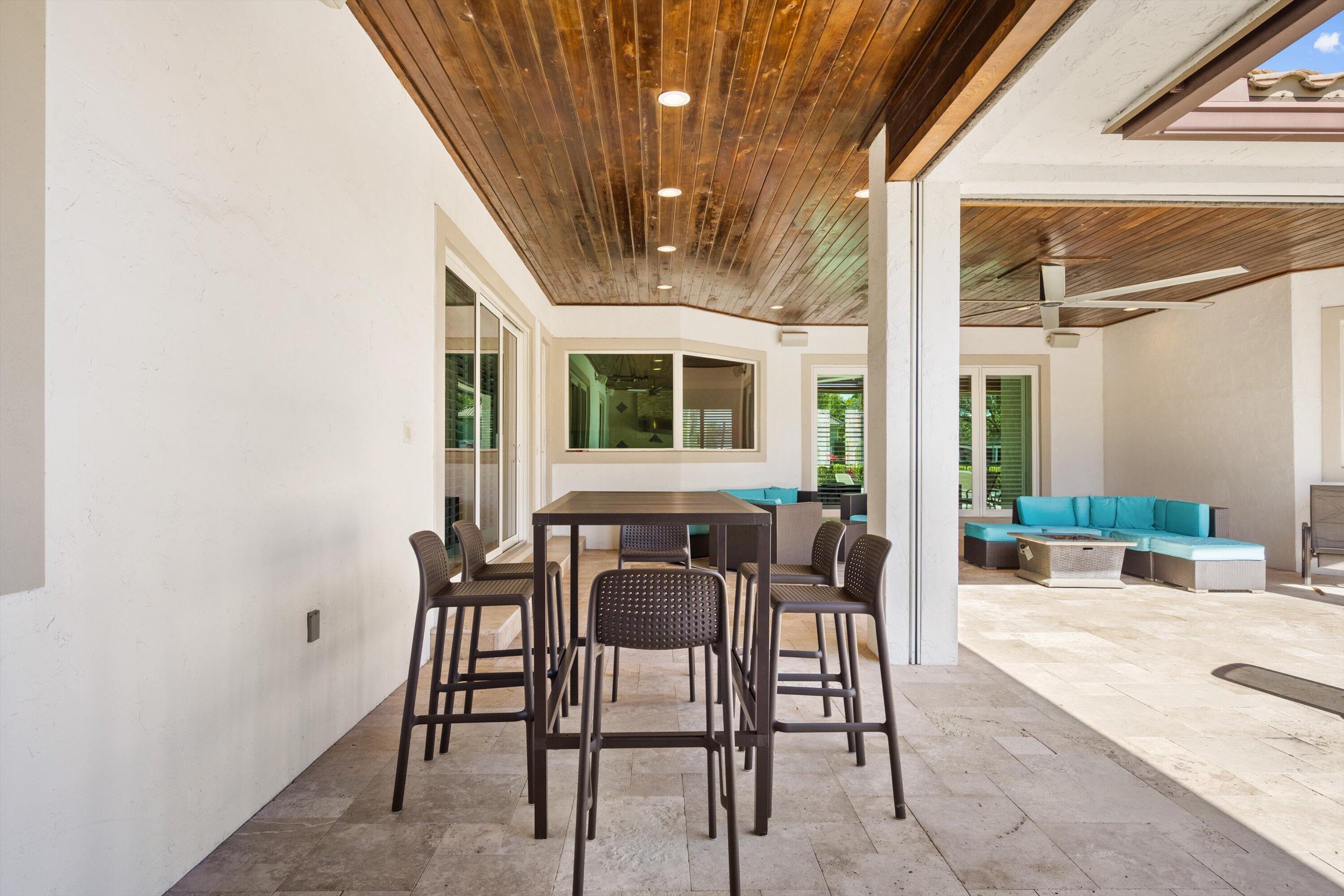 15880 Barnstormer Court Wellington, FL 33414 - Photo 39 of 48 a view of a patio with table and chairs and potted plants