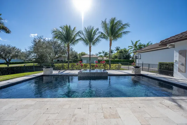 a view of a swimming pool with a patio and a garden