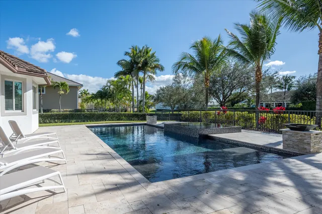 a view of swimming pool with outdoor seating and plants