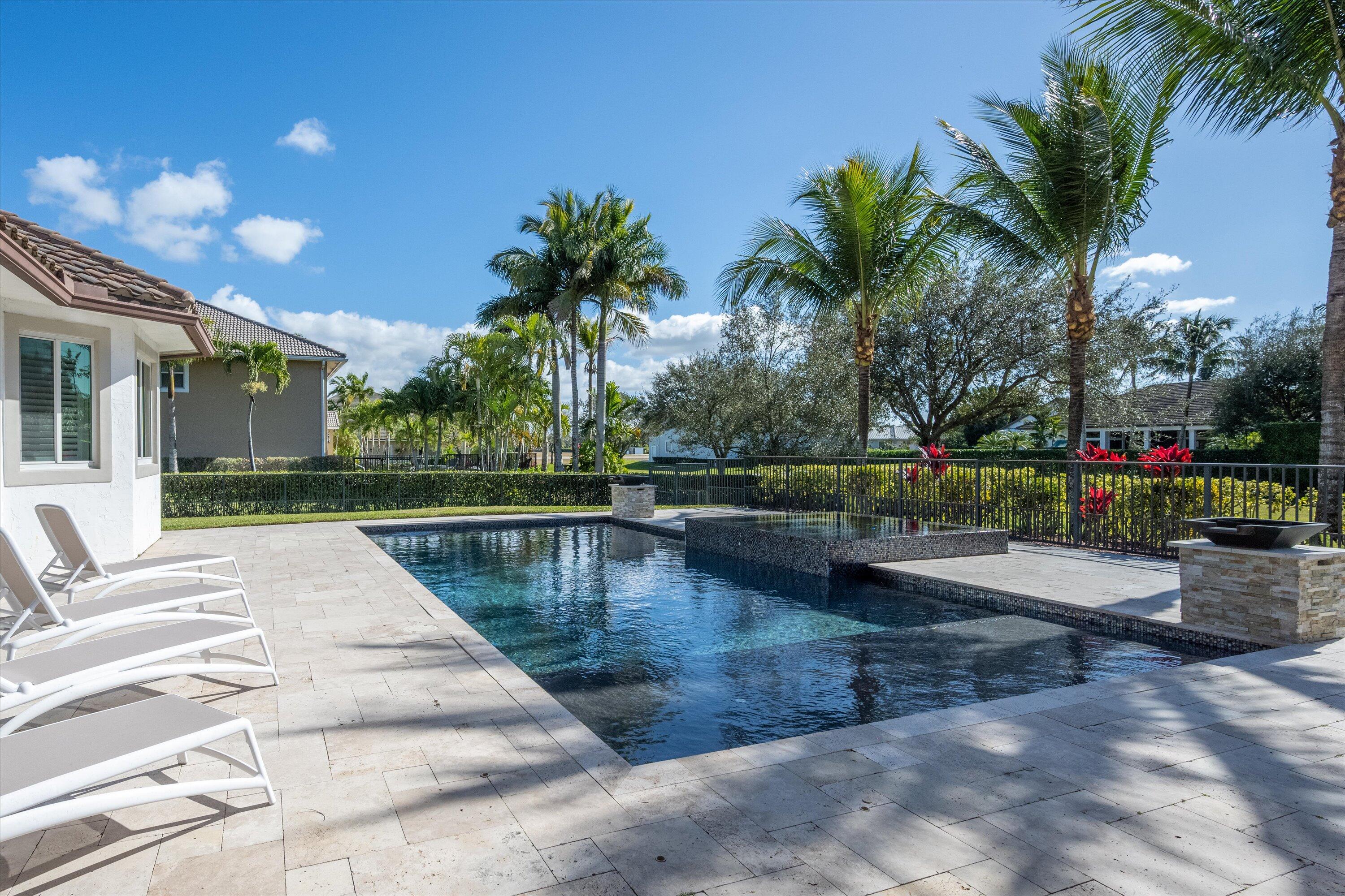 15880 Barnstormer Court Wellington, FL 33414 - Photo 43 of 48 a view of swimming pool with outdoor seating and plants