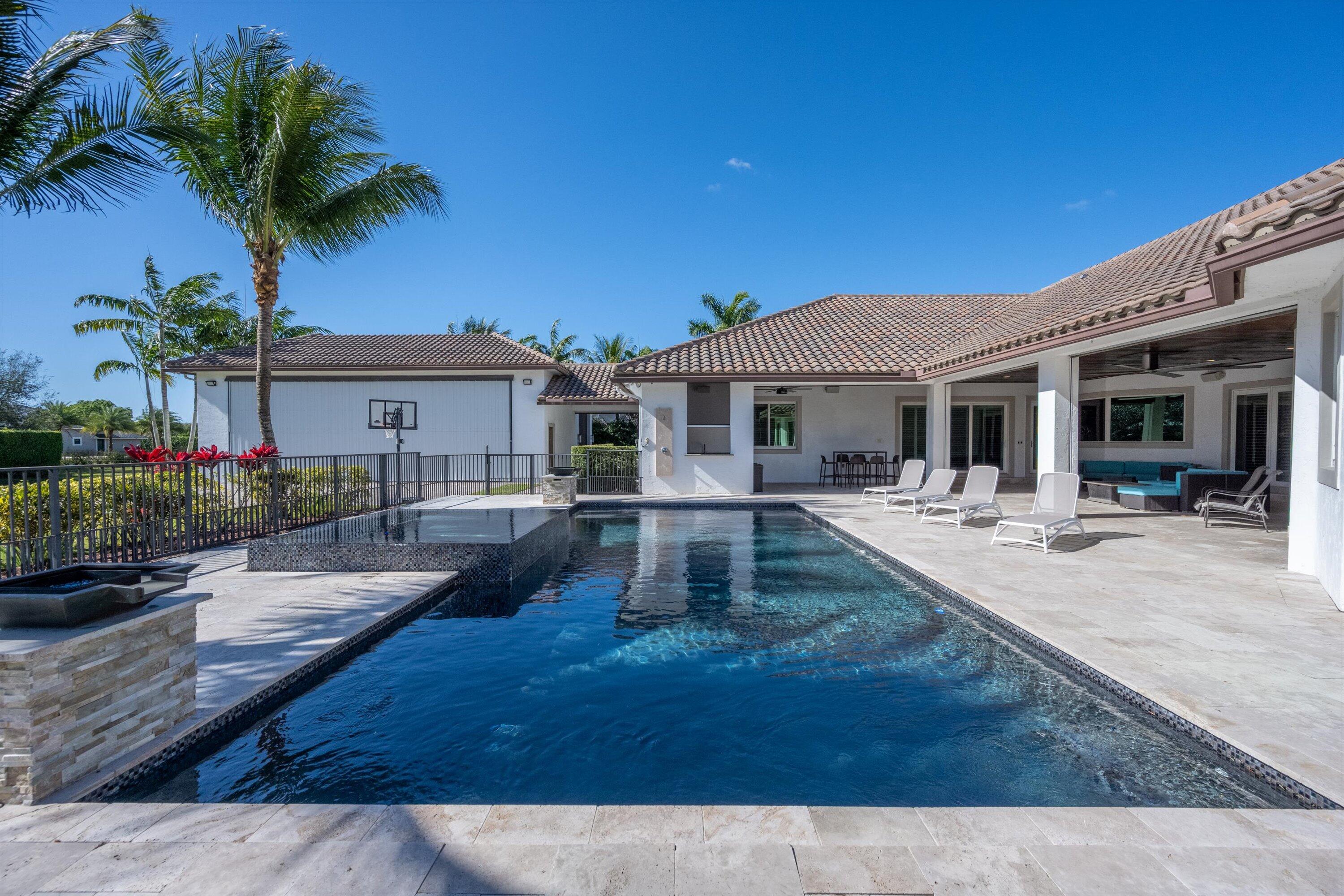 15880 Barnstormer Court Wellington, FL 33414 - Photo 45 of 48 a front view of a house with garden