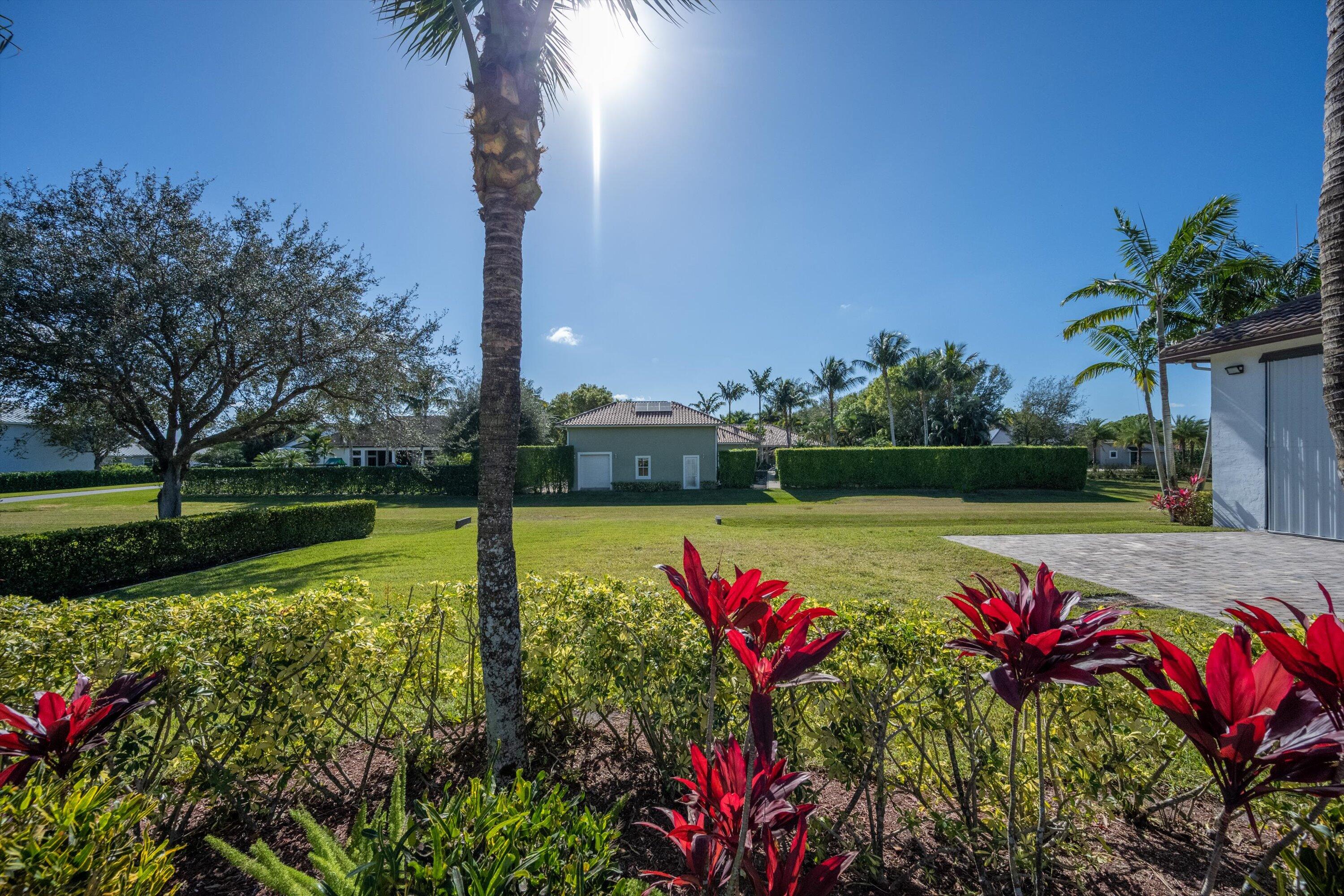 15880 Barnstormer Court Wellington, FL 33414 - Photo 47 of 48 a view of a fountain in front of a house with a big yard