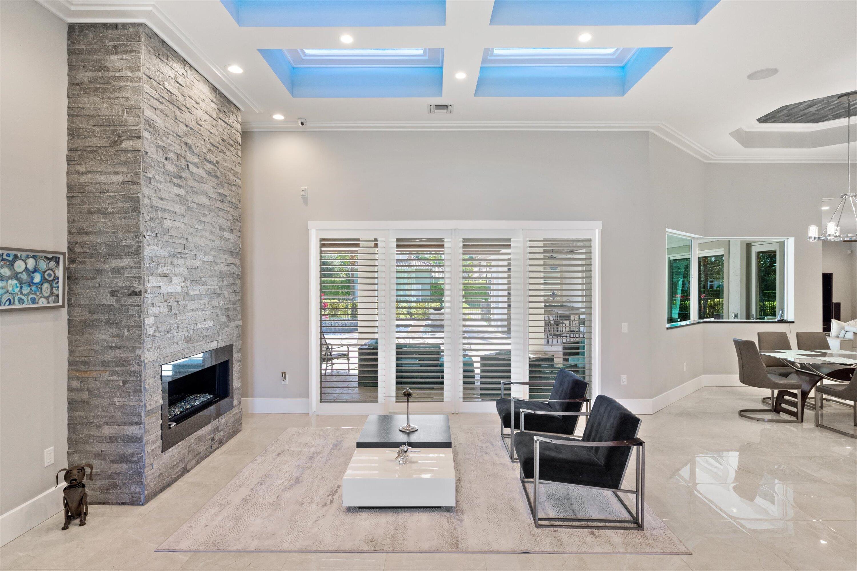 15880 Barnstormer Court Wellington, FL 33414 - Photo 5 of 48 a living room with furniture windows and a fireplace