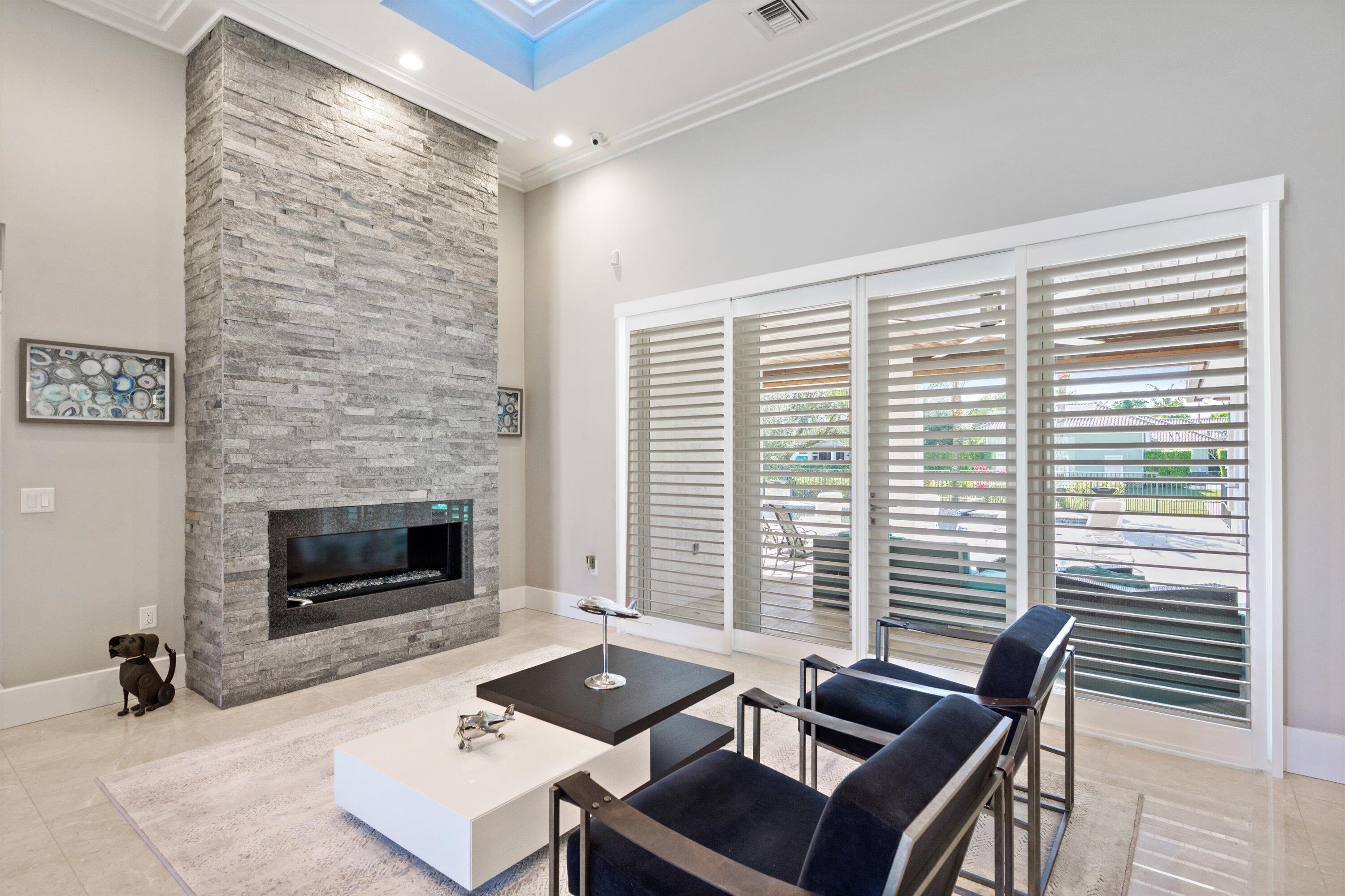 15880 Barnstormer Court Wellington, FL 33414 - Photo 6 of 48 a living room with furniture and a fireplace