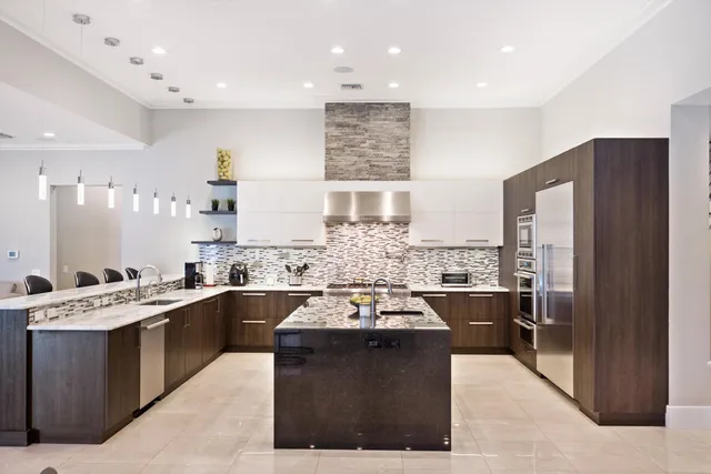 a large kitchen with a large counter top appliances and cabinets