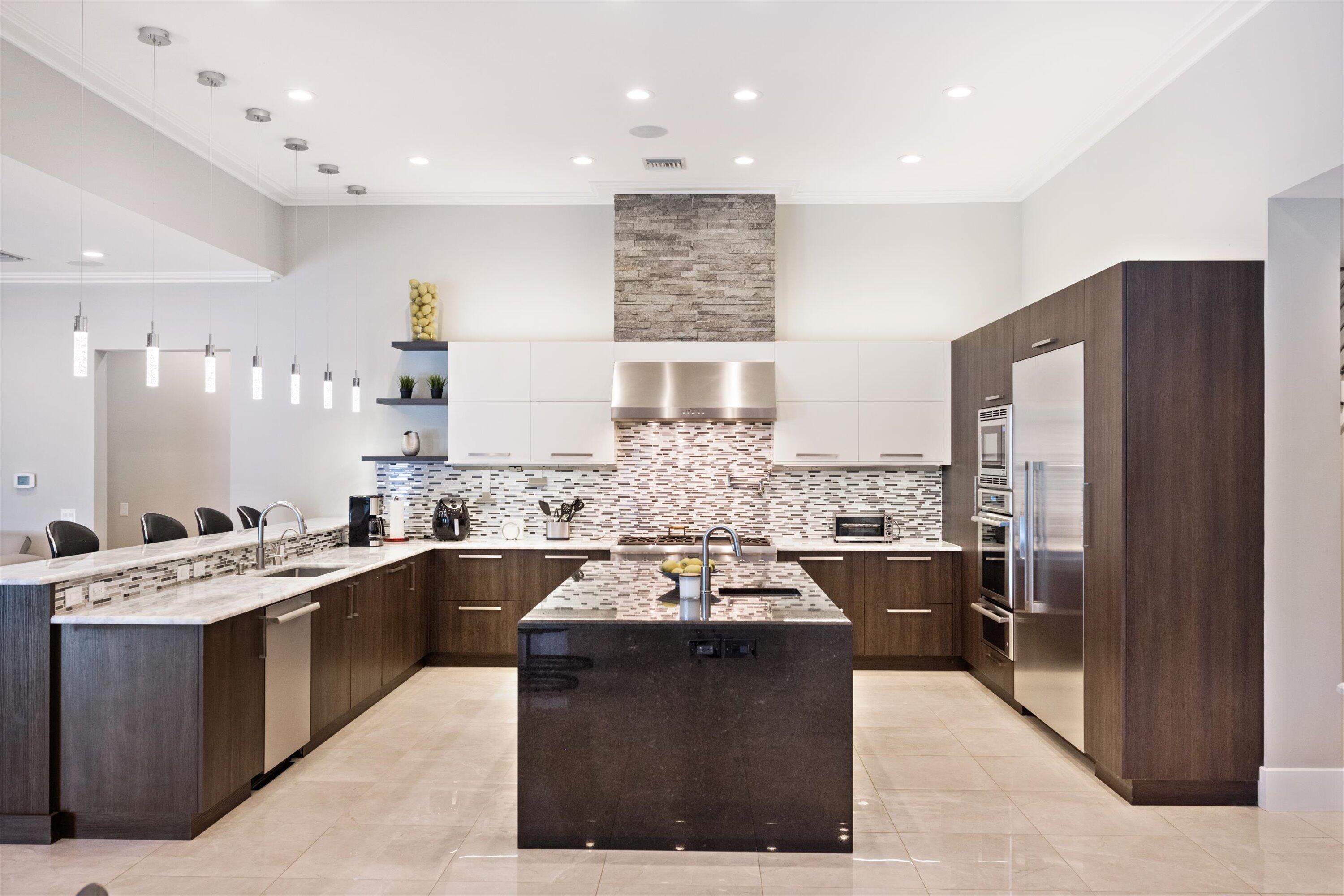 15880 Barnstormer Court Wellington, FL 33414 - Photo 10 of 48 a large kitchen with a large counter top appliances and cabinets