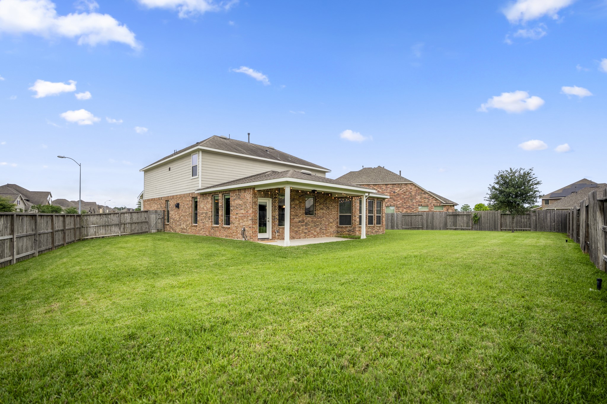 7502 Windsor Park Court Spring, TX 77379 - Photo 41 of 50 Moving beyond the patio, the scale of the backyard starts to shine — a fully fenced outdoor space with room to spread out, while the covered patio stays connected to the main living areas inside.
