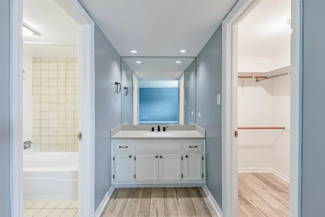 a view of bathroom with a sink mirror and shower
