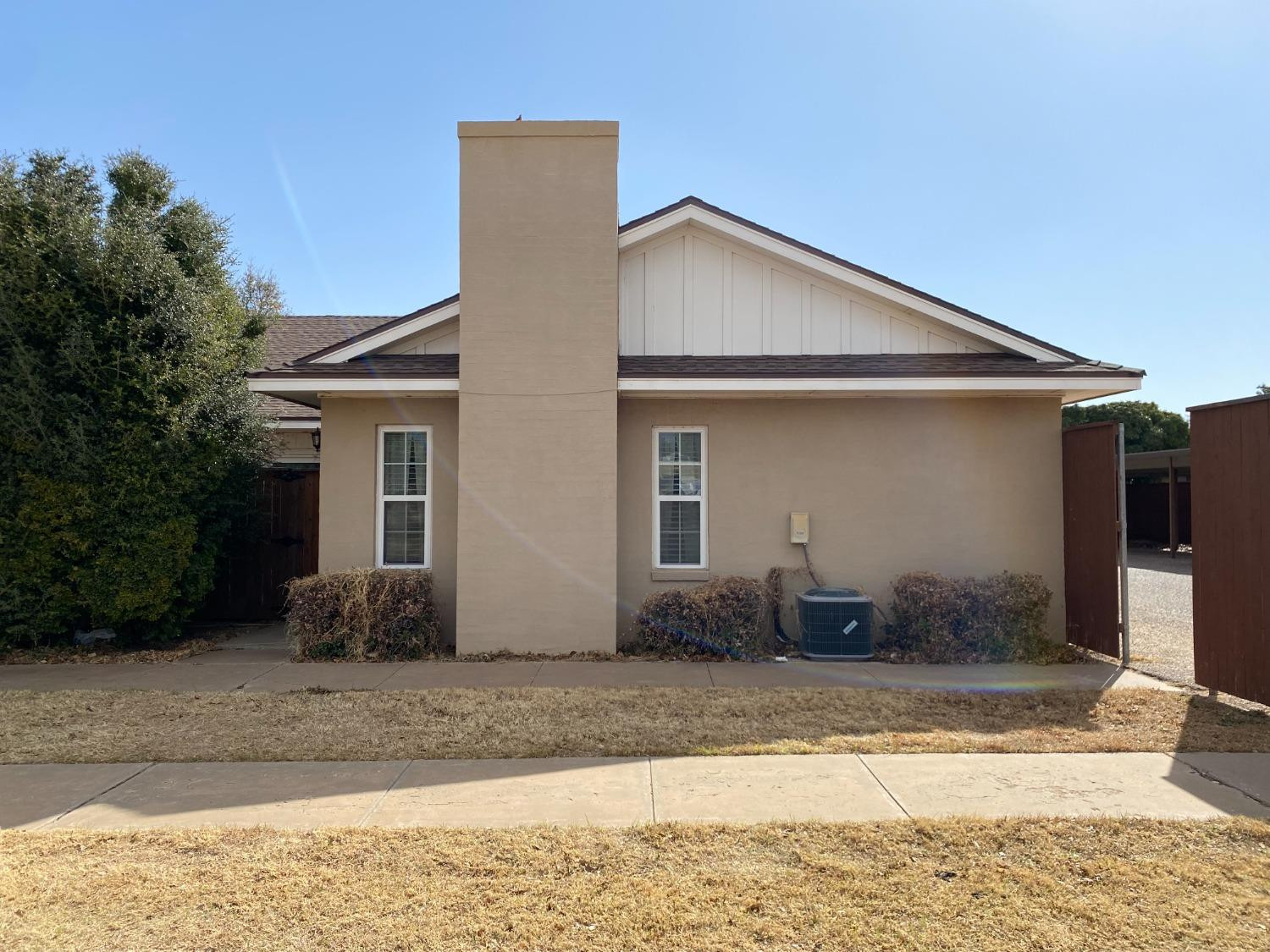 3235 64th Street Lubbock, TX 79413 - Photo 2 of 11 a front view of a house with garden