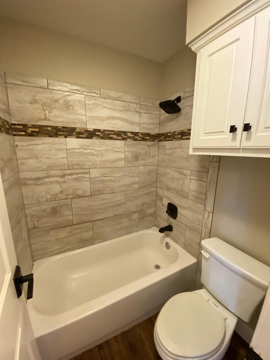 3235 64th Street Lubbock, TX 79413 - Photo 9 of 11 a bathroom with a toilet and a bathtub