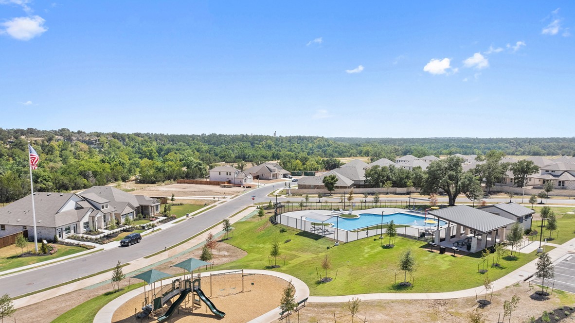113 Shadow Oak Cove Georgetown, TX 78628 - Photo 40 of 40 An aerial perspective reveals a serene community with a playground, swimming pool, and pavilion.