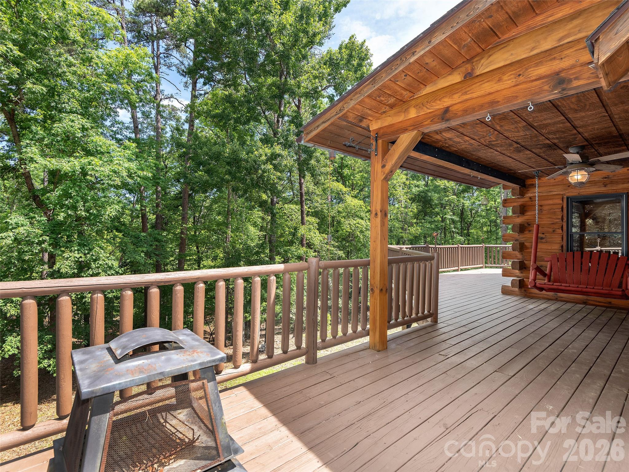 413 Green Hills Road Mill Spring, NC 28756 - Photo 40 of 48 a view of a wooden deck with a patio
