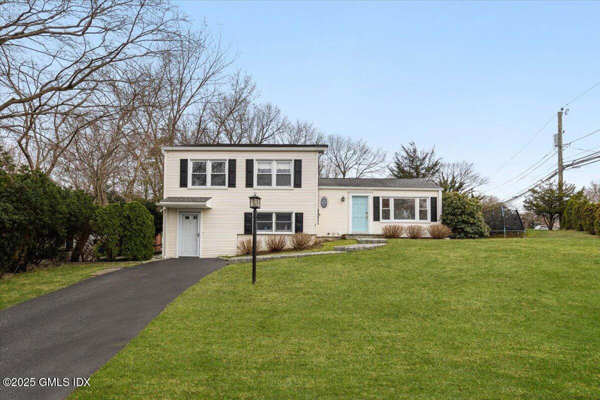 12 Mary Lane Riverside, CT 06878 - Photo 1 of 26 a front view of a house with a garden